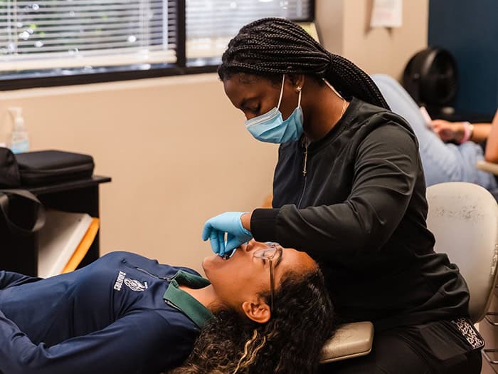 Assistant working on patient at Laster Orthodontics